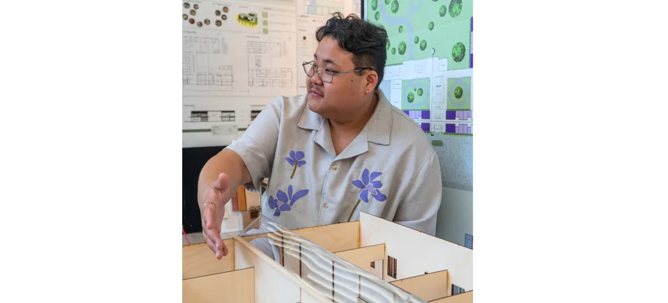 a student presents a model of a memory care facility