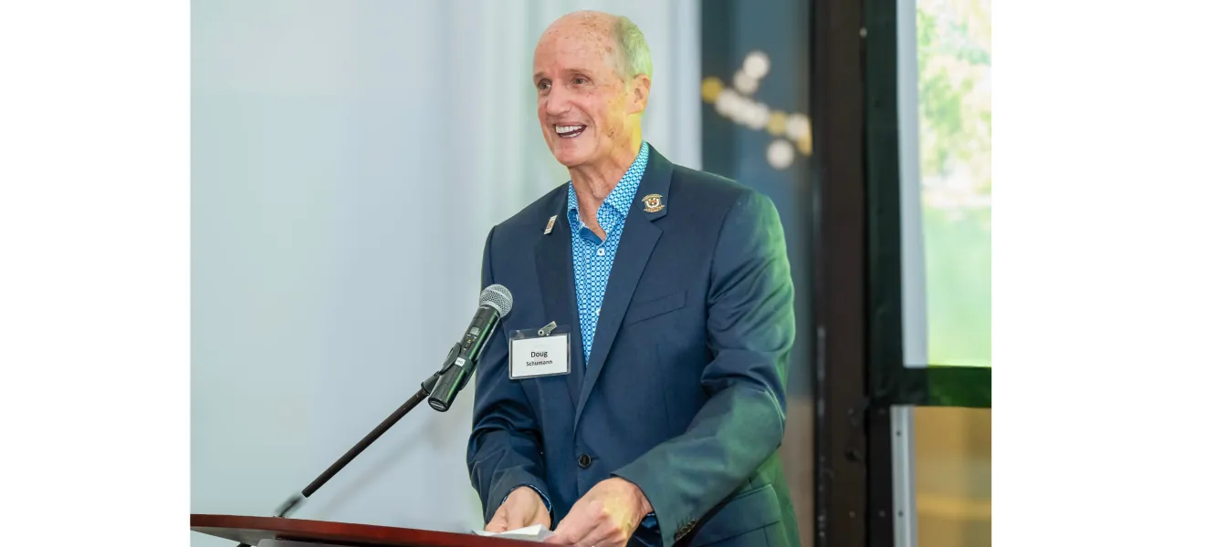 a man smiles at a podium