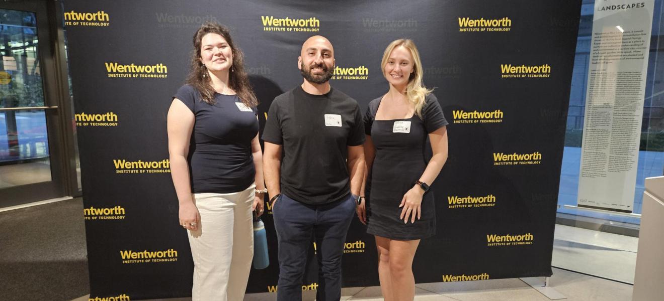 three people pose in front of a wall that says "wentworth"