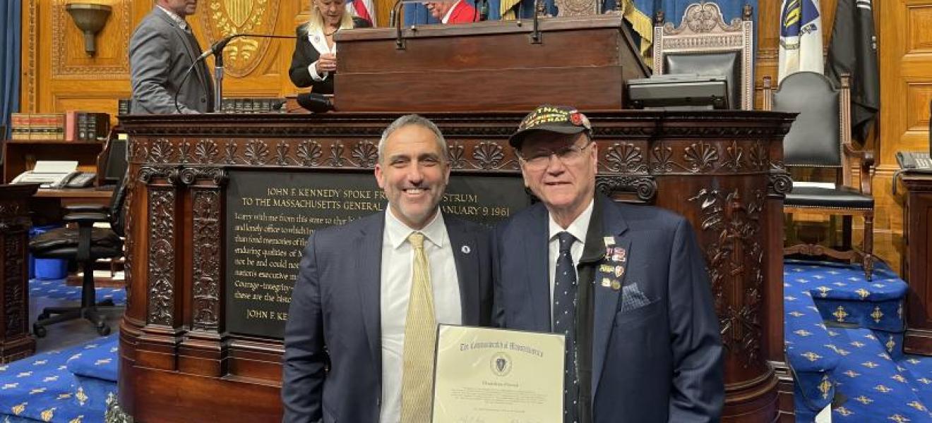 two men holding a proclamation at Boston's State House