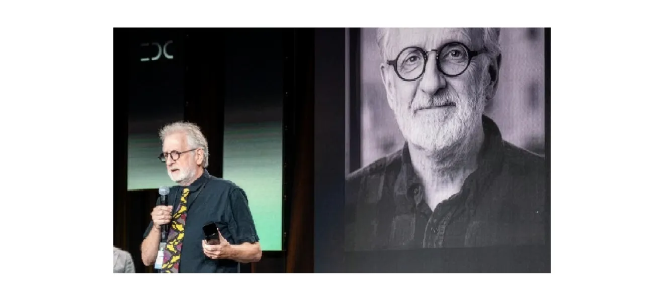 a man speaks on stage at an awards event