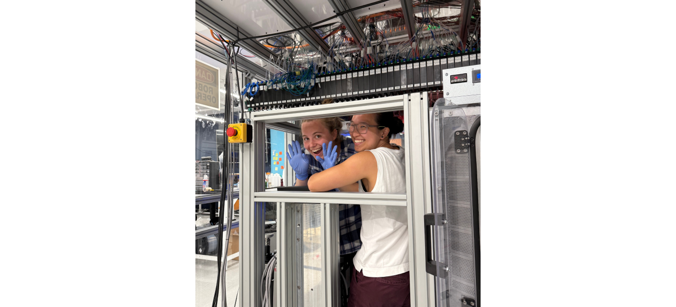two women in front of a machine