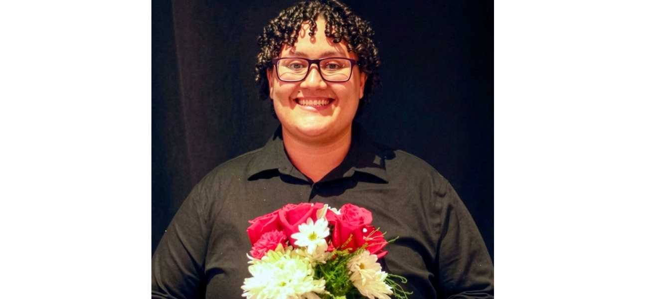 a smiling woman holds flowers