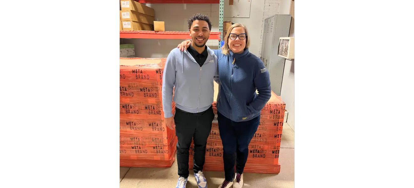 two people standing in front of pallets of beverages