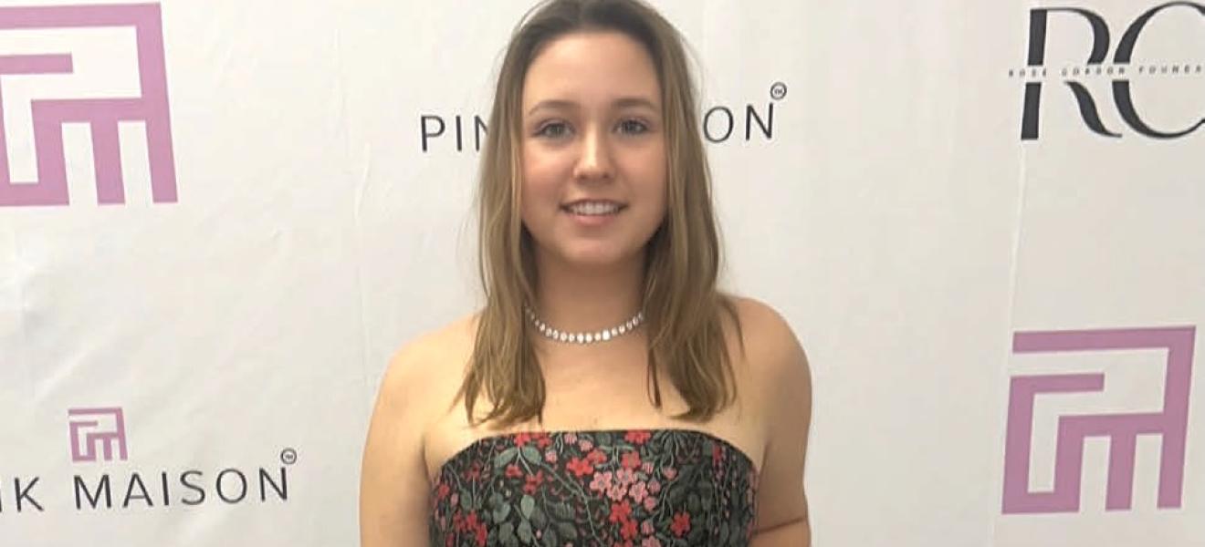 a woman in a dress on a red carpet