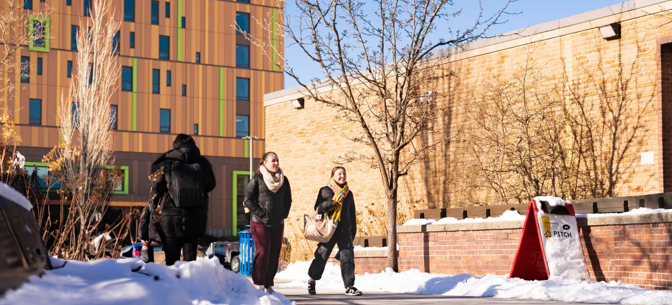 people walking through a snowy walkway