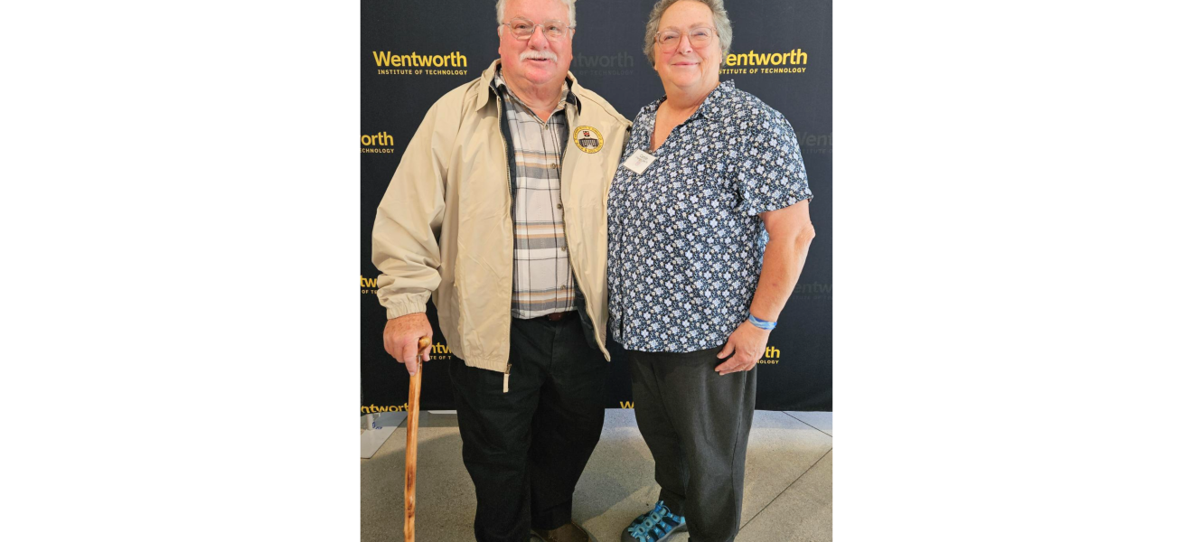 two people standing in front of a wentworth background
