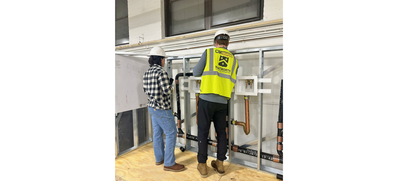 people in hard hats working in a plumbing related lab