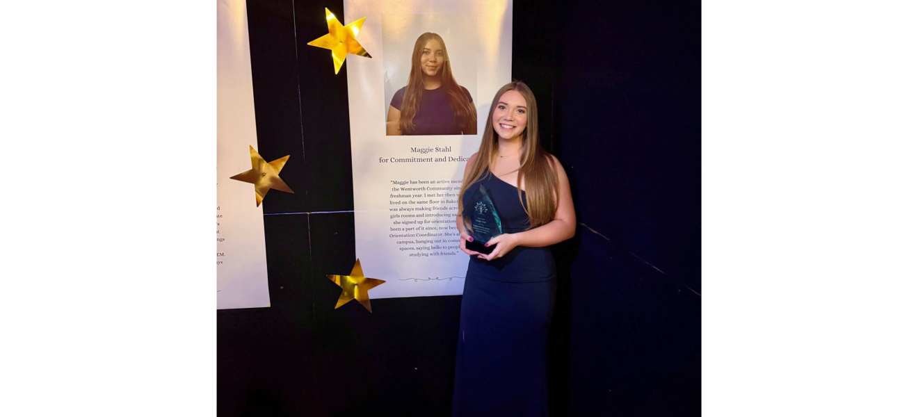 a woman in a black dress holds up an award