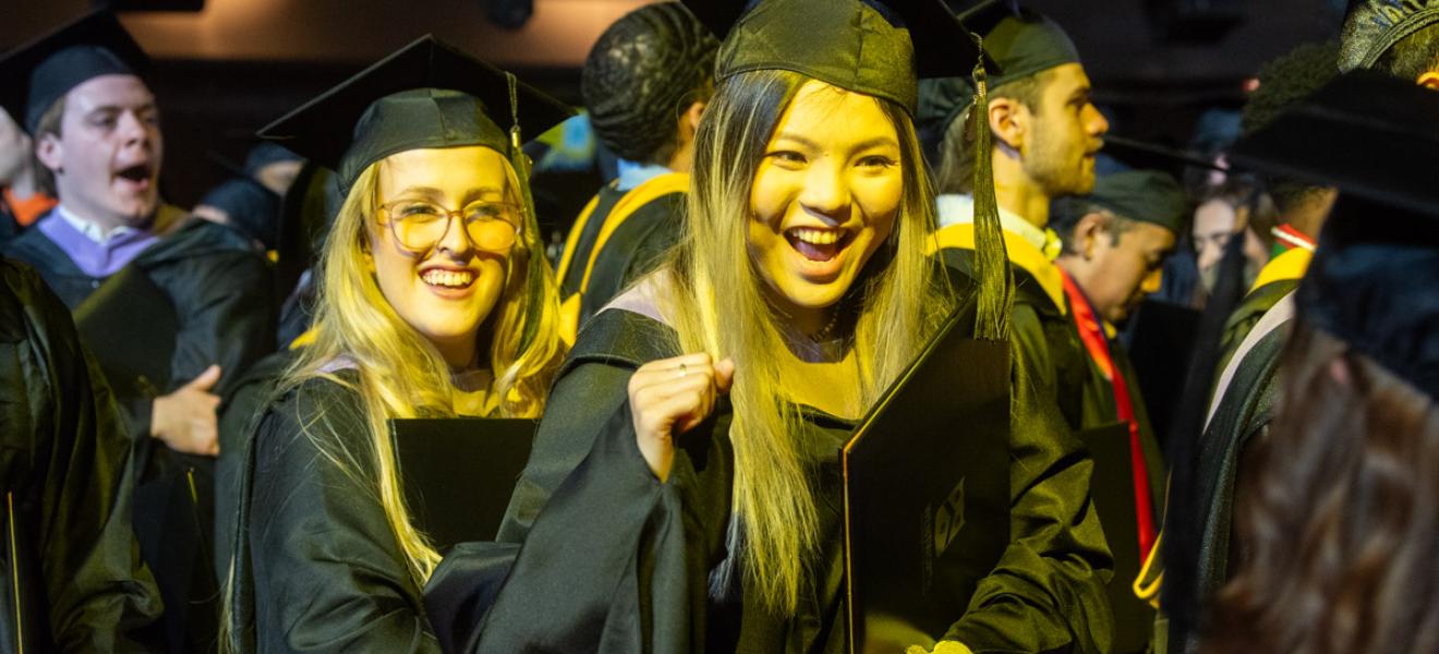 very happy students in graduation robes