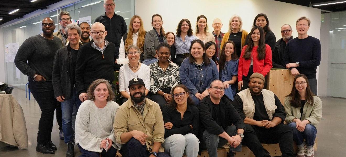 a large group of people posing for a photo together