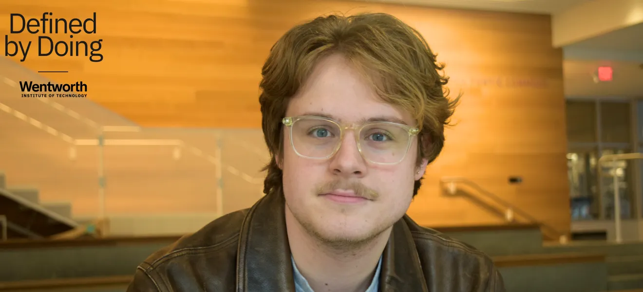 portrait of a man wearing glasses and a leather jacket