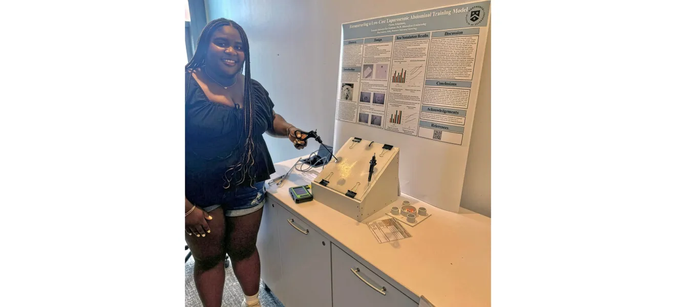 a woman poses with a medical device she created