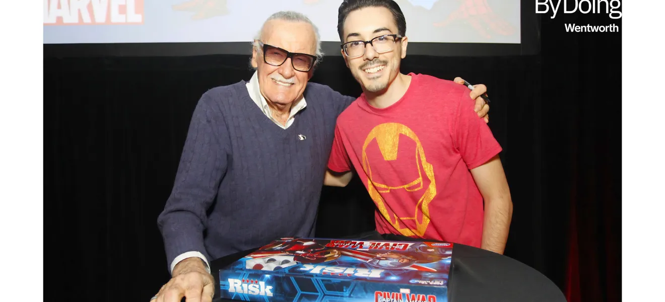 two men pose with a board game