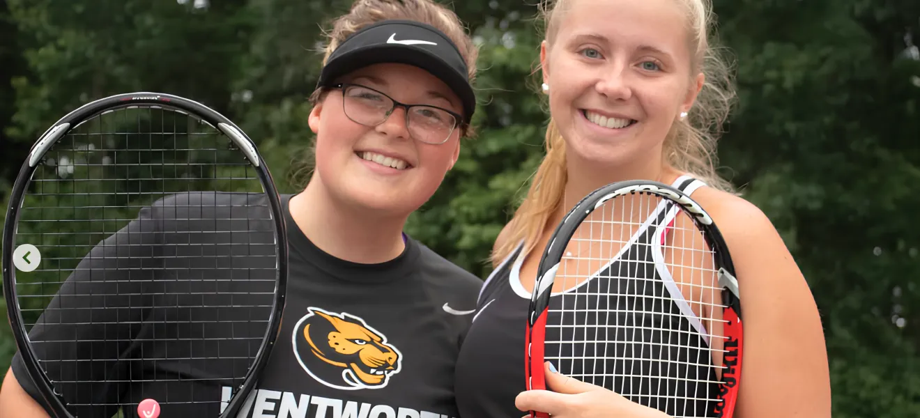 two women holding tennis rackets and wearing clothing that reads "wentworth leopards"