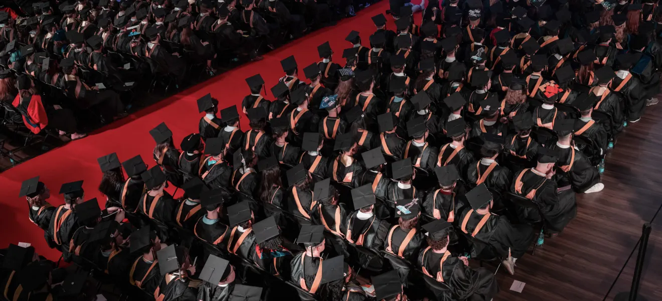 rows of students wearing graduation caps
