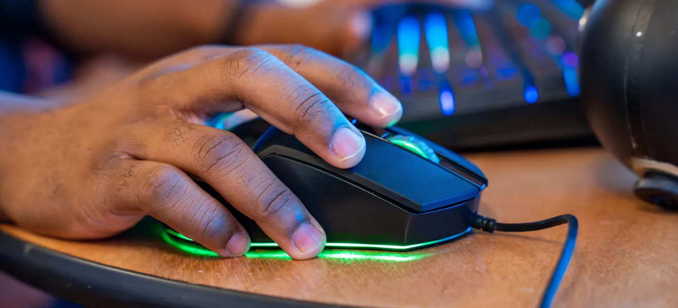 a hand on a computer mouse