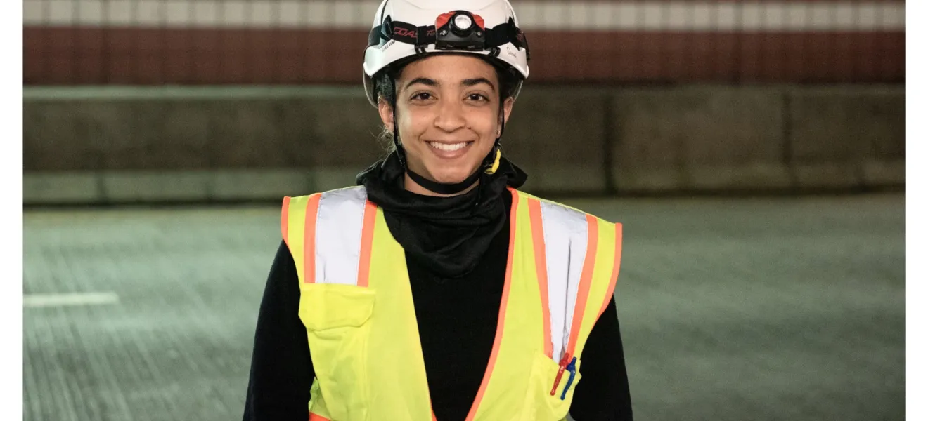 a woman wearing a hard hat and vest