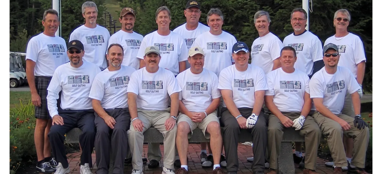 a large group of men wearing white t-shirts on a golf course