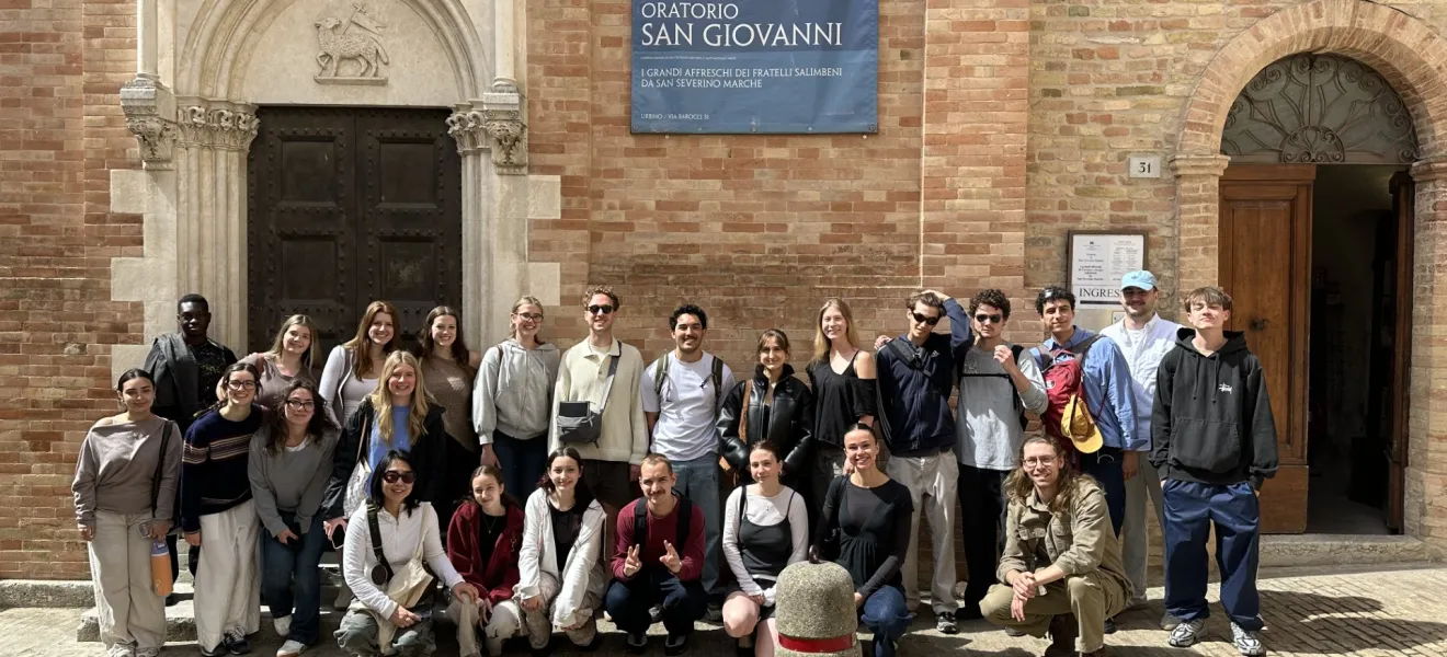 students in front of a european building