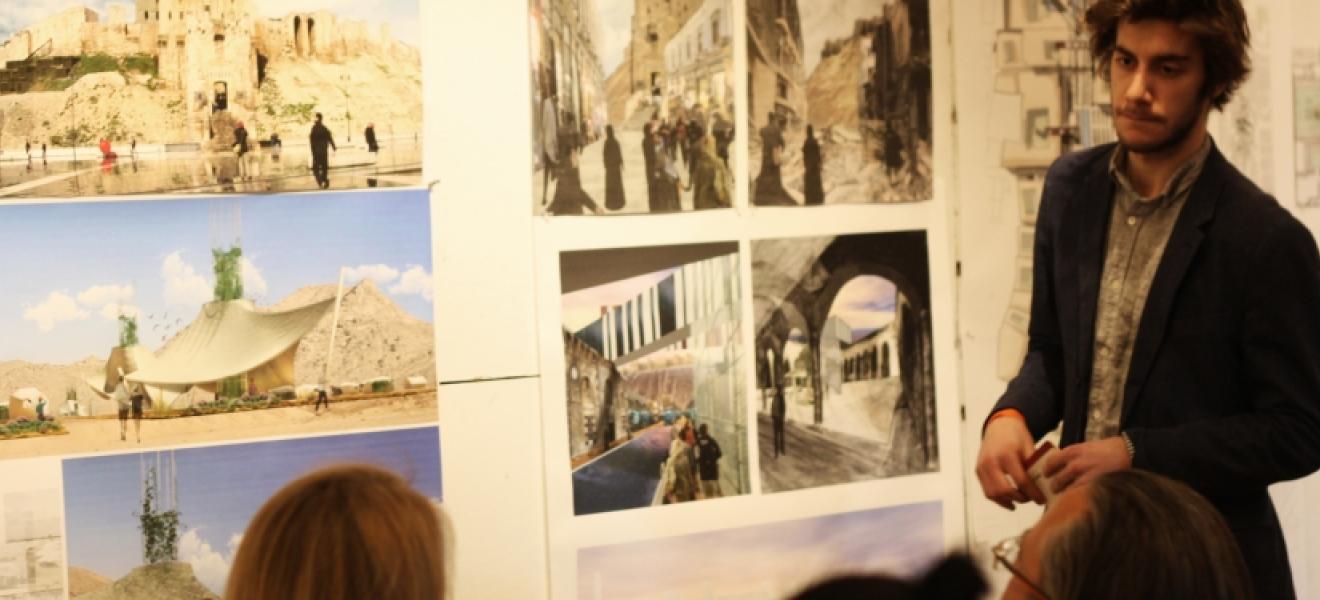 man presenting architectural work to a group of people
