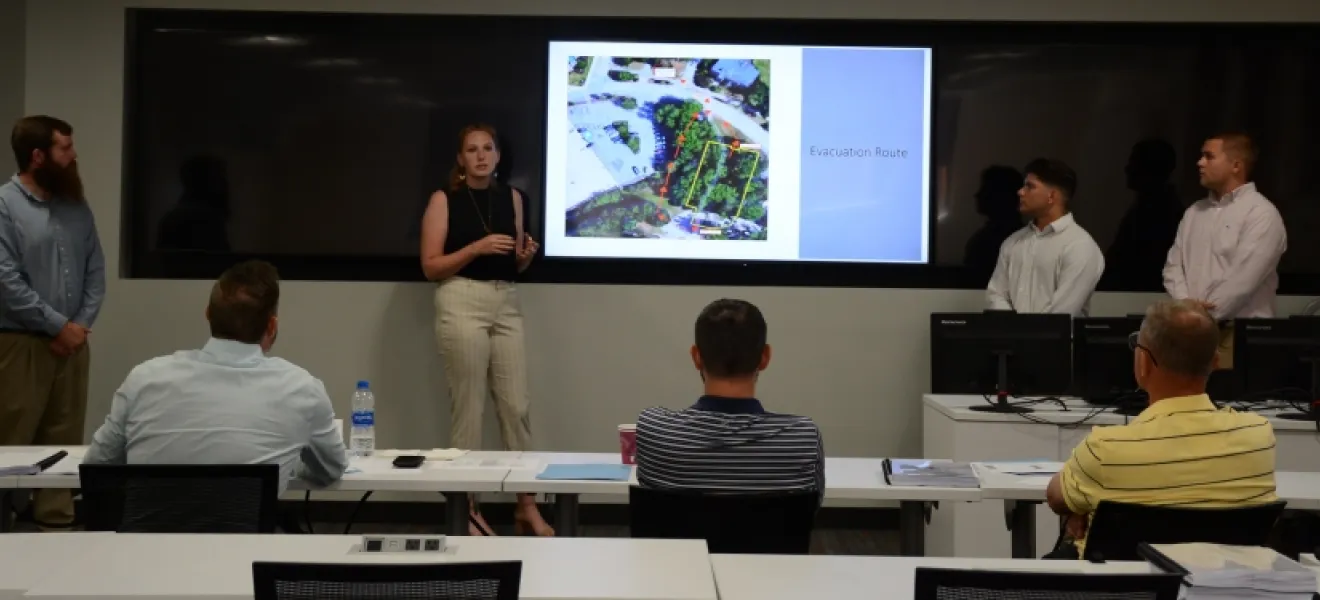 A group of students present projects to judges