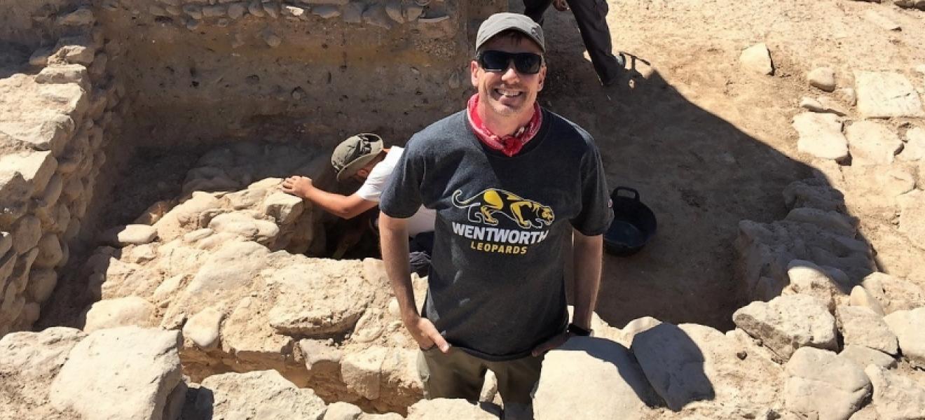 people standing in an archaeological dig site