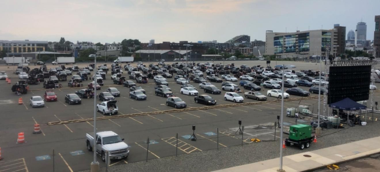 cars parked for a drive-in movie theater