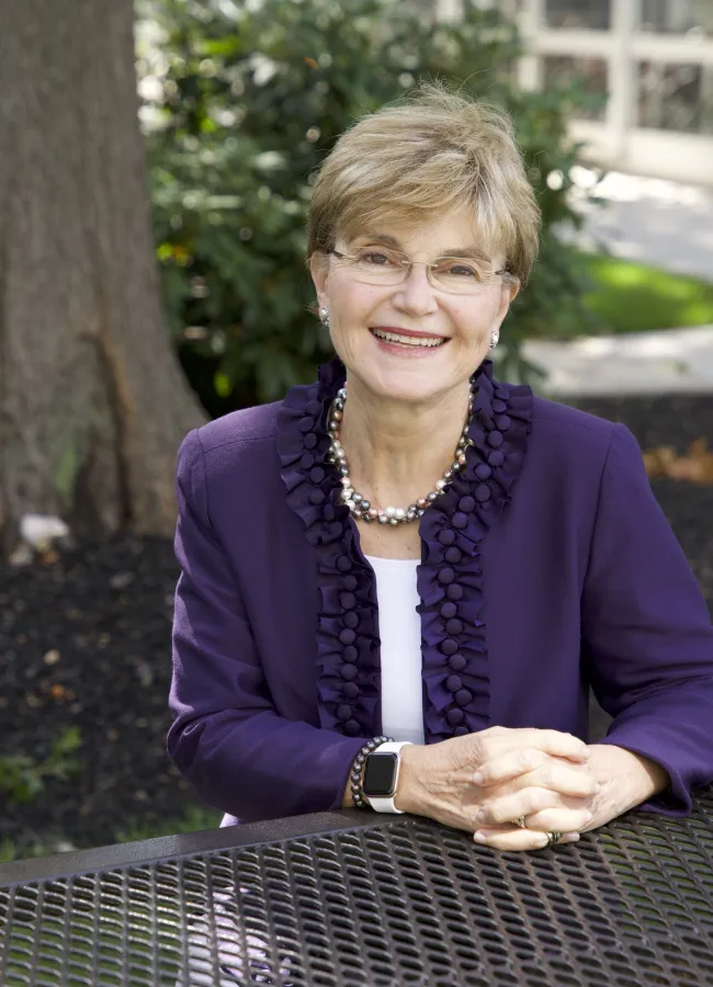a woman sitting at a bench