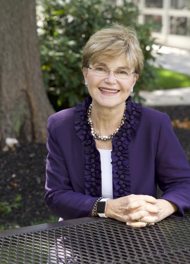 a woman sitting at a bench
