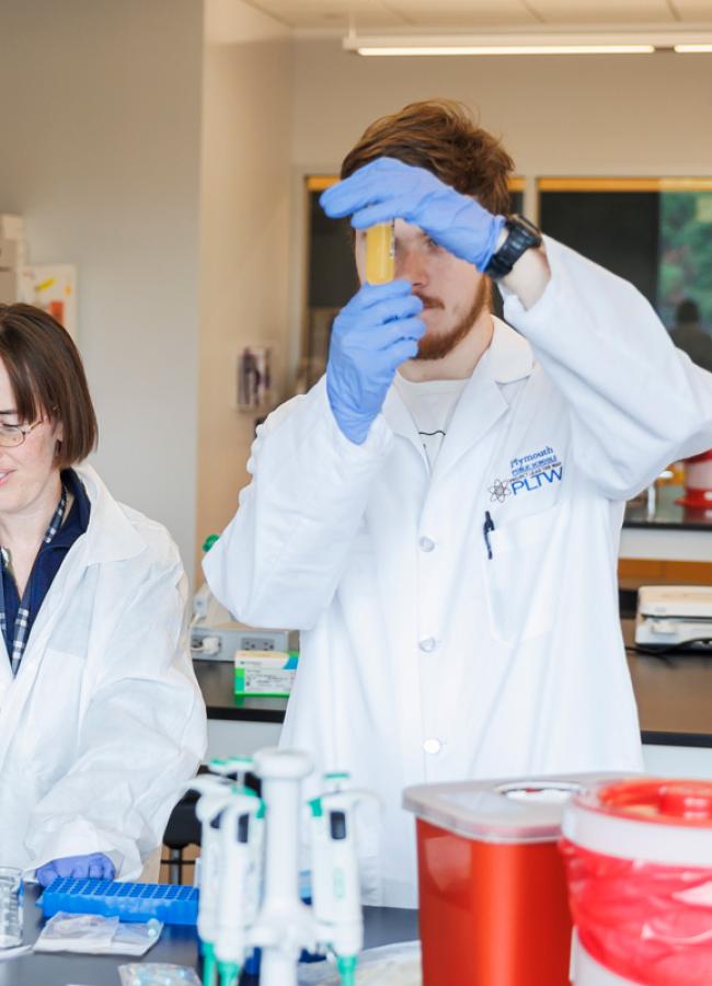 Mary Machado works with bioengineering students in the lab