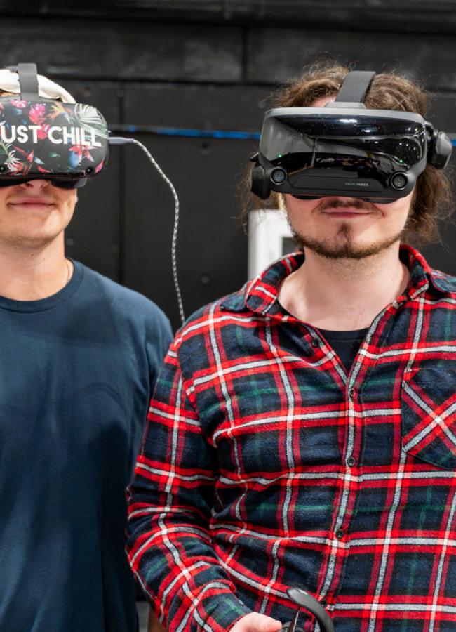 Dylan O'Brien and Owen Terry wearing VR headsets at the Computer Engineering capstone